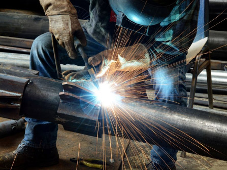 Construction workers using grinders to smooth materials on site