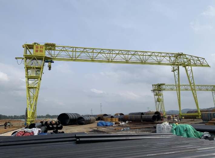 gantry crane lifting heavy load at a construction site