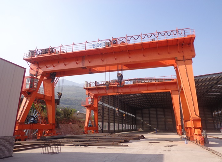 Industrial box type gantry crane moving heavy loads in warehouse environment